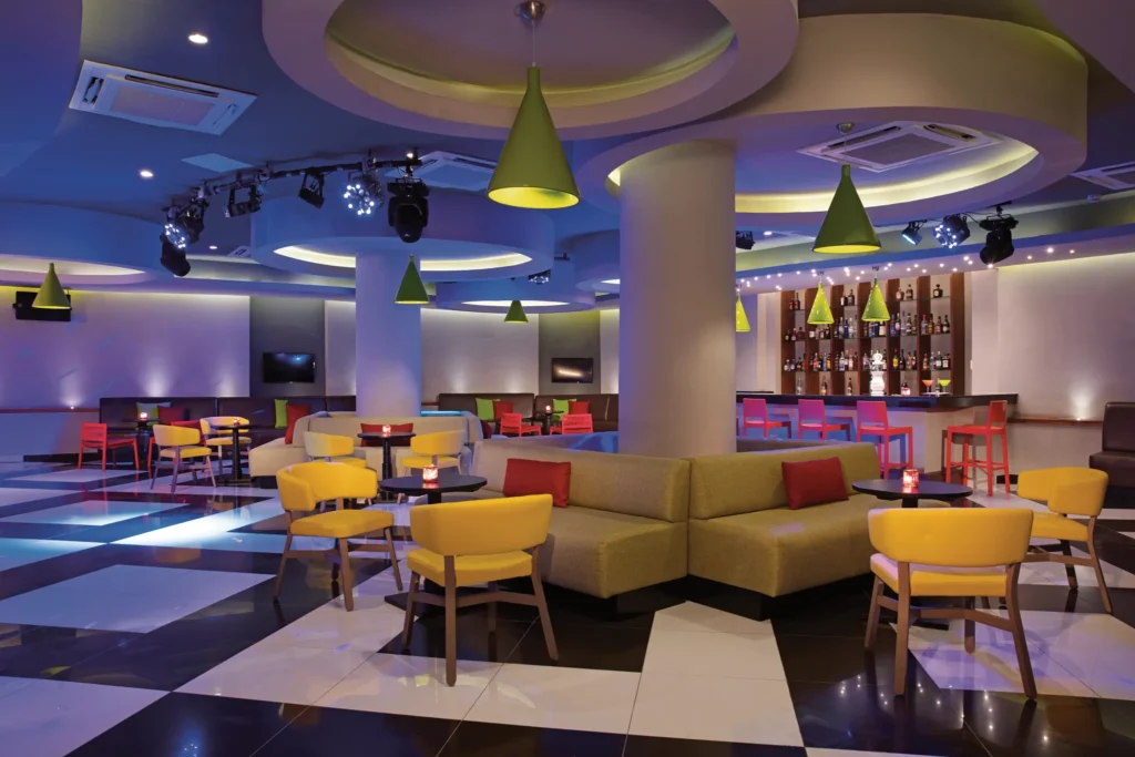 Desires nightclub at Dreams Dominicus La Romana featuring vibrant lighting, modern lounge seating, and energetic late-night entertainment.