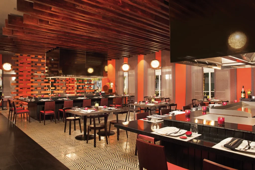 Himitsu Asian restaurant at Dreams Dominicus La Romana featuring contemporary teppanyaki tables, sushi bar, and elegant Asian-inspired décor.