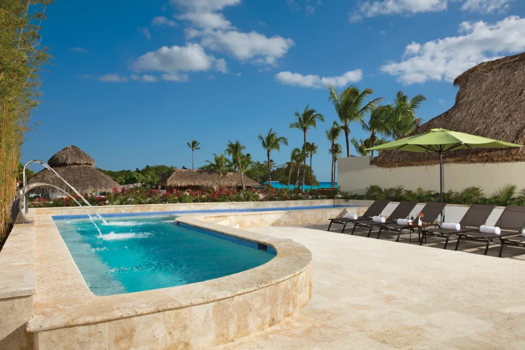 Outdoor hydrotherapy spa pool with lounge chairs at Dreams Dominicus La Romana Resort.