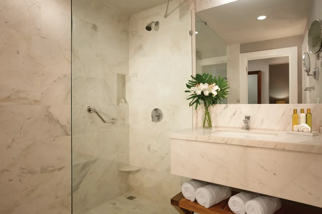 Preferred Club Deluxe Pool View bathroom with marble walk-in shower and modern vanity at Dreams Dominicus La Romana.