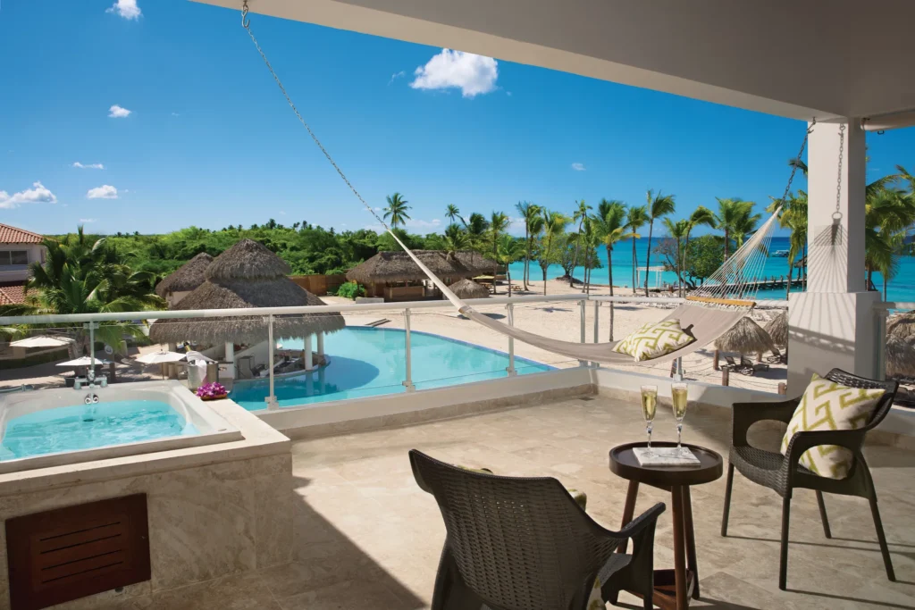 Preferred Club Honeymoon Suite terrace with hot tub, hammock, and partial ocean views at Dreams Dominicus La Romana.