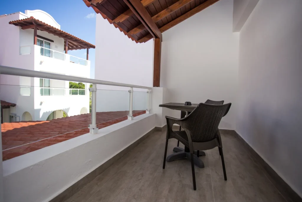 Private furnished balcony at the Preferred Club Master Suite at Dreams Dominicus La Romana with outdoor seating and resort views.