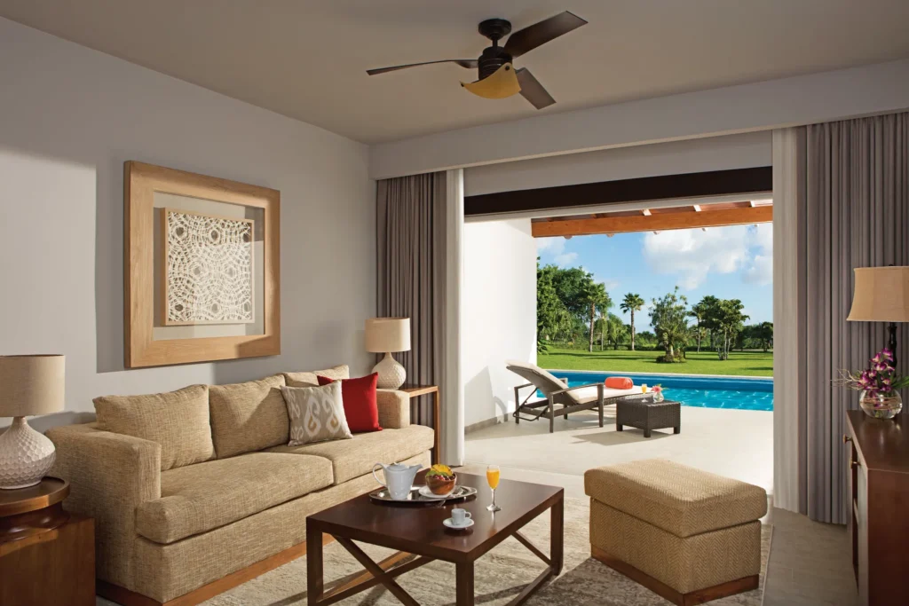Preferred Club Suite Swim-Up living area with sofa and terrace access at Dreams Dominicus La Romana.