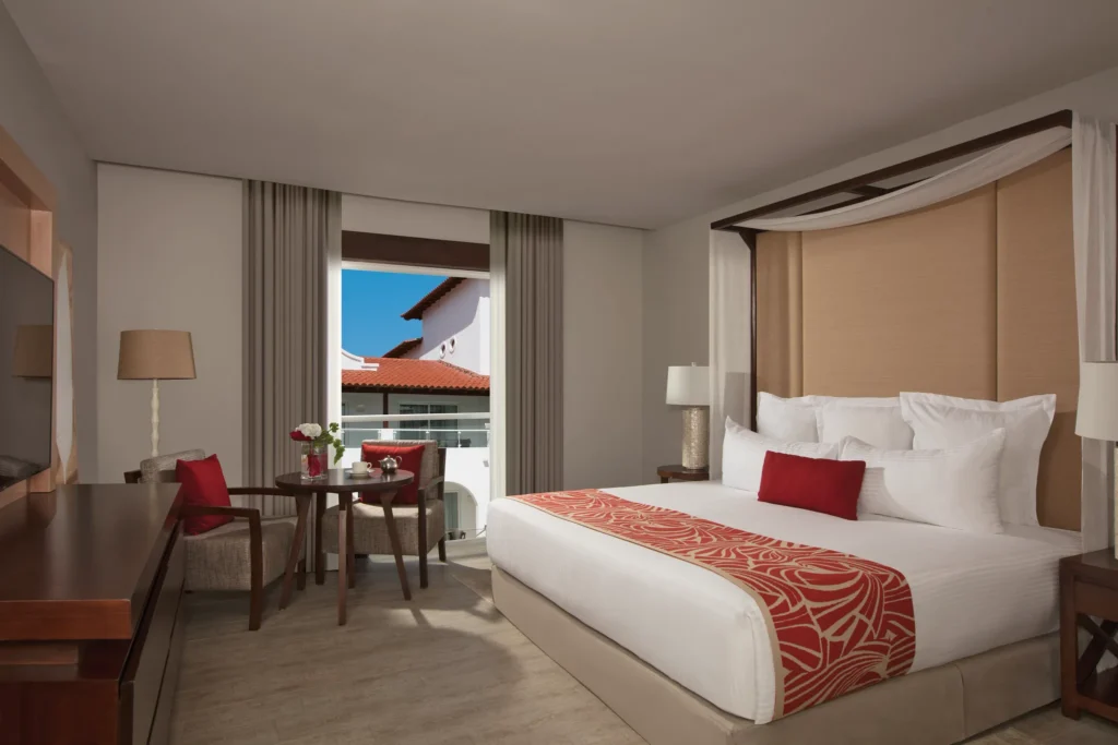 Preferred Club Suite Tropical View with king bed and private balcony at Dreams Dominicus La Romana Resort.