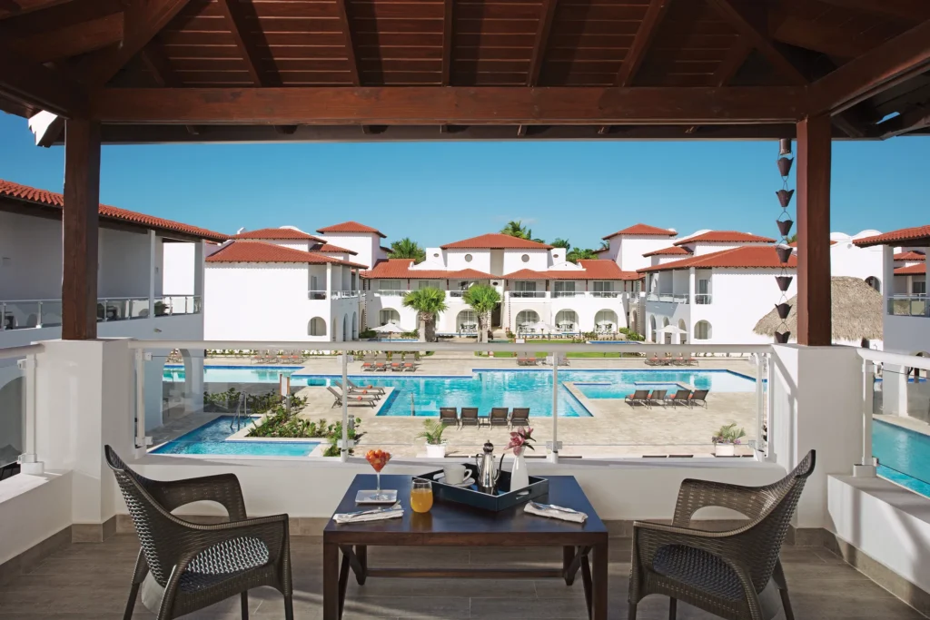 Private furnished terrace with pool and garden views at Preferred Club Suite Tropical View at Dreams Dominicus La Romana.
