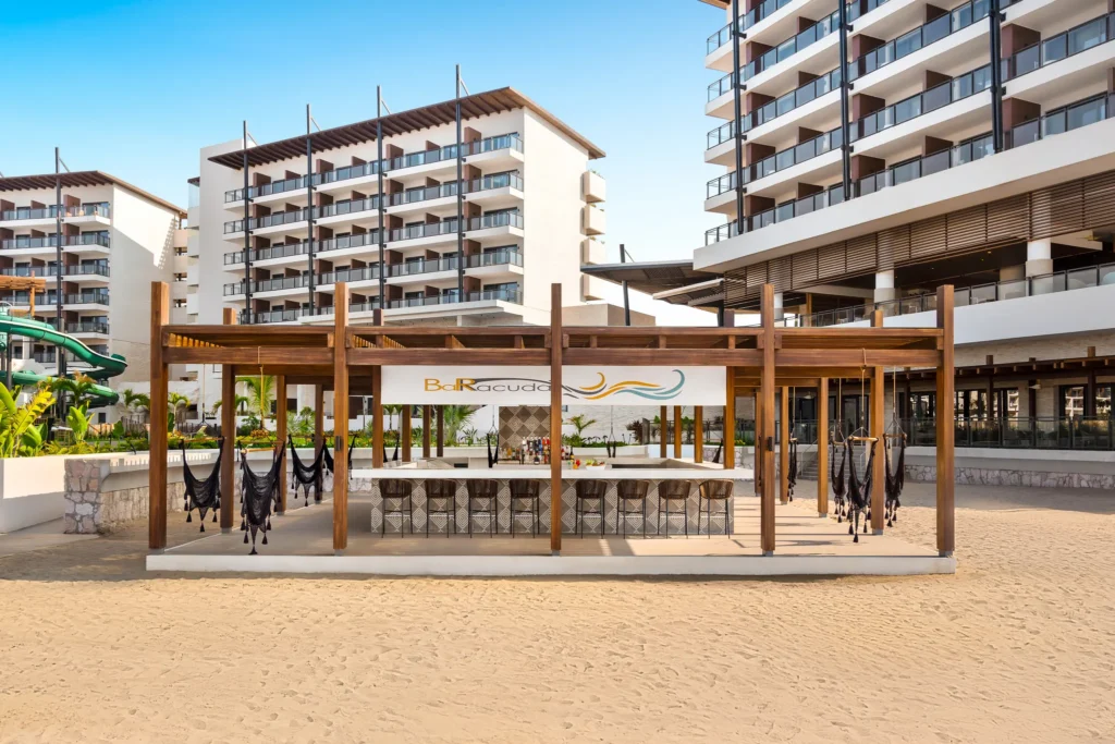 Barracuda Beach Bar at Dreams Estrella del Mar Mazatlan featuring a stylish open-air beachfront bar with hammocks and tropical cocktails.