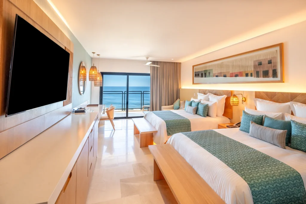 Deluxe Suite Ocean View with two double beds and balcony overlooking the Pacific Ocean at Dreams Estrella del Mar Mazatlan.