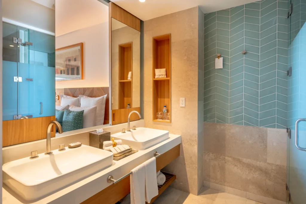 Deluxe Suite Ocean View bathroom with double sinks and glass walk-in shower at Dreams Estrella del Mar Mazatlan Resort.