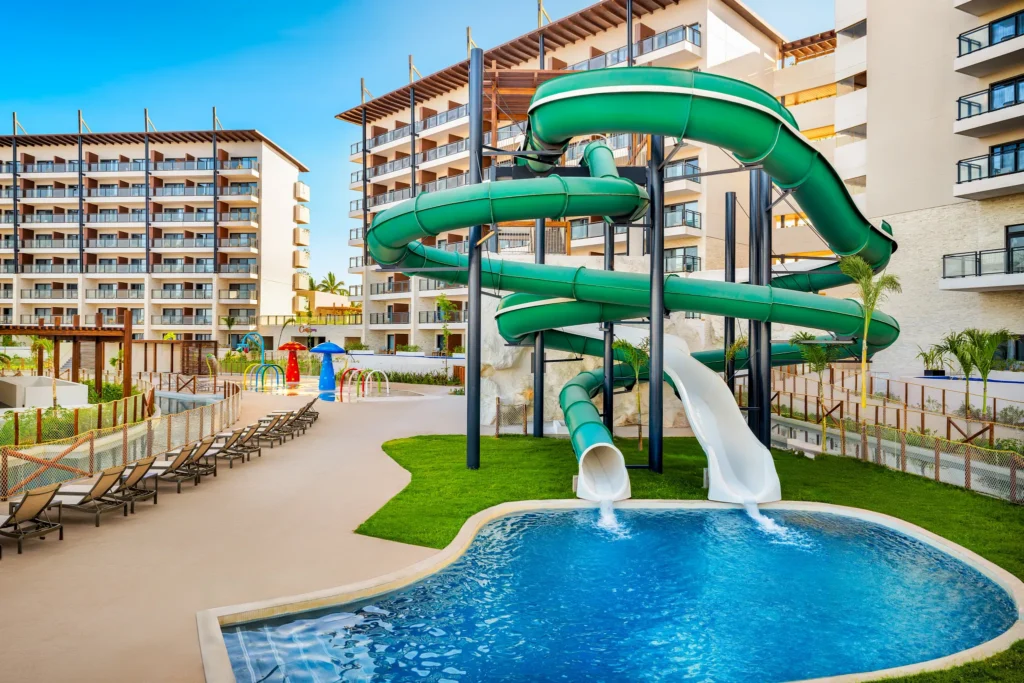 Green waterslides and splash area at the waterpark inside Dreams Estrella del Mar Mazatlan Golf & Spa Resort.