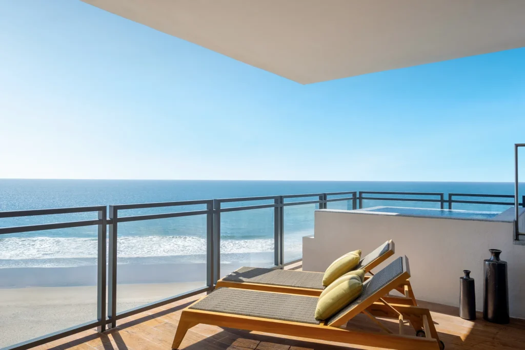 One-Bedroom Presidential Suite Ocean Front balcony with loungers and outdoor hot tub at Dreams Estrella del Mar Mazatlan.