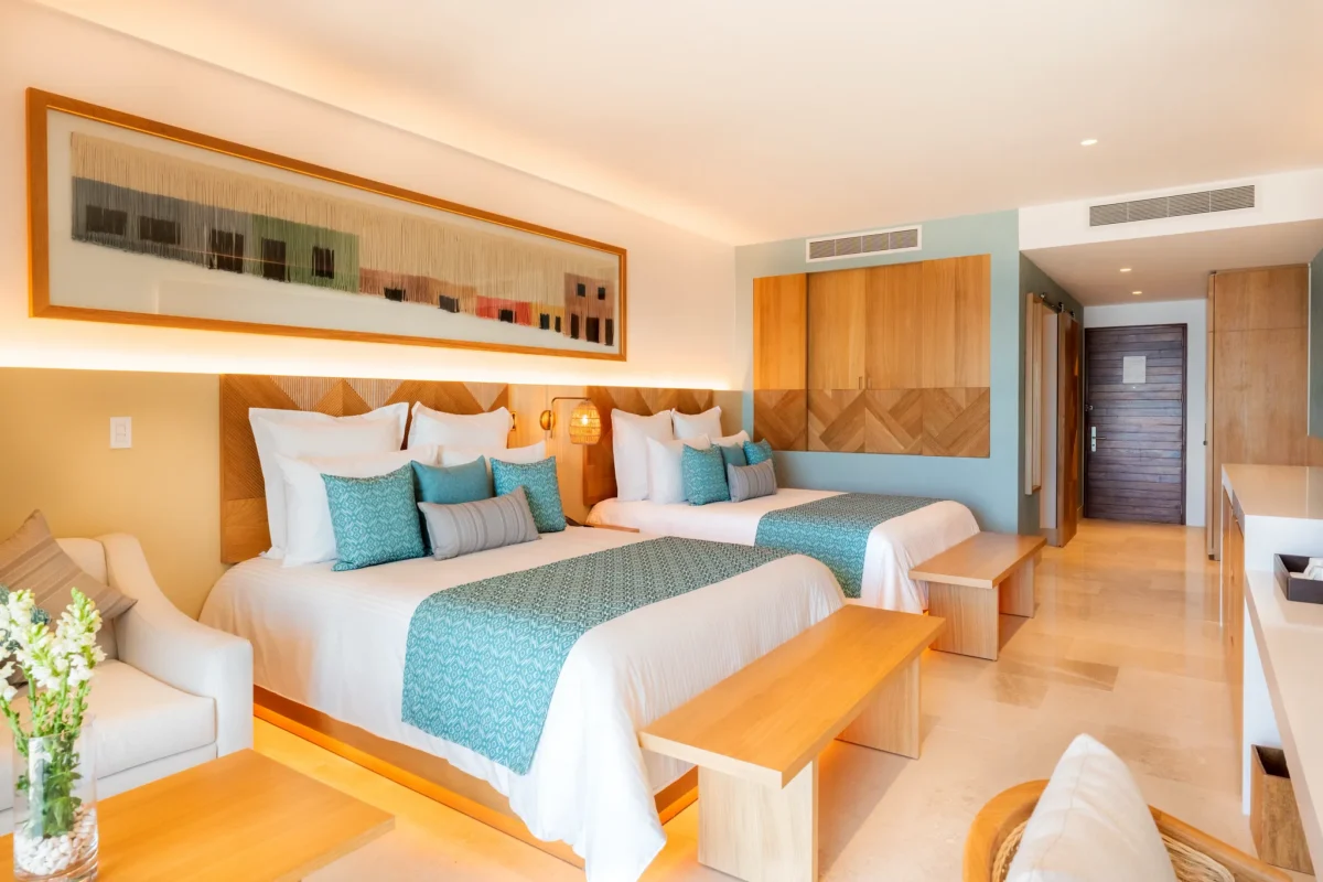 Preferred Club Junior Suite Ocean Front with two double beds and modern coastal design at Dreams Estrella del Mar Mazatlan.