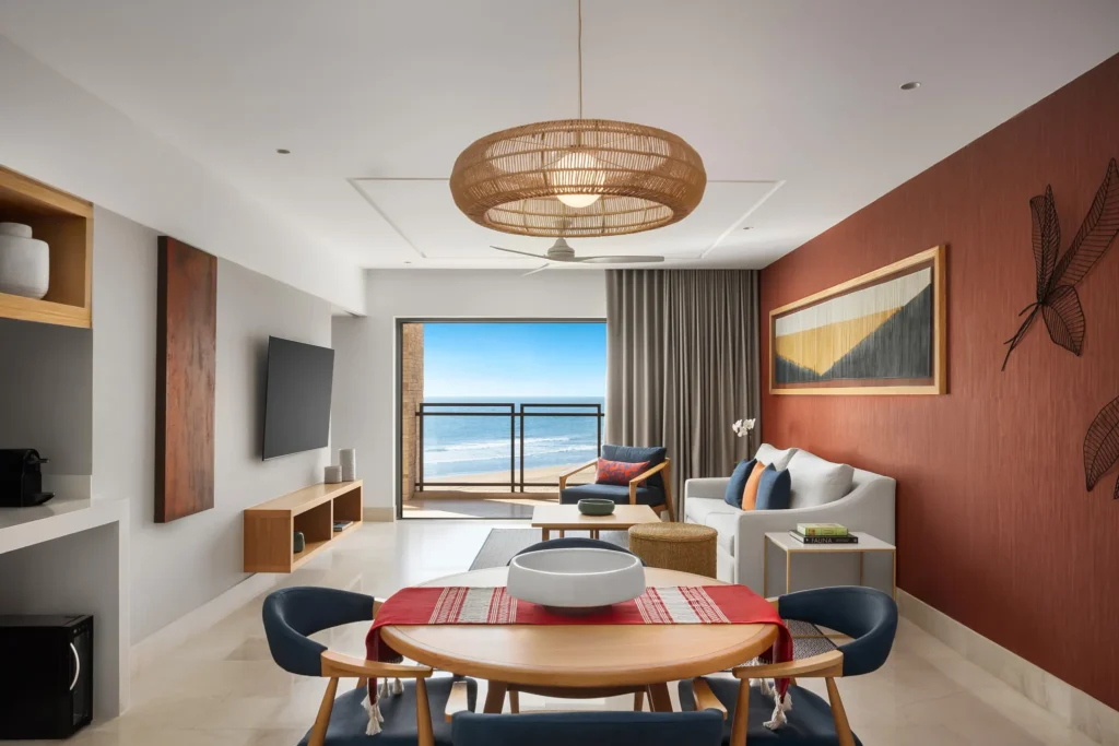 Preferred Club Premium Master Suite Ocean Front living and dining area with ocean-view balcony at Dreams Estrella del Mar Mazatlan.
