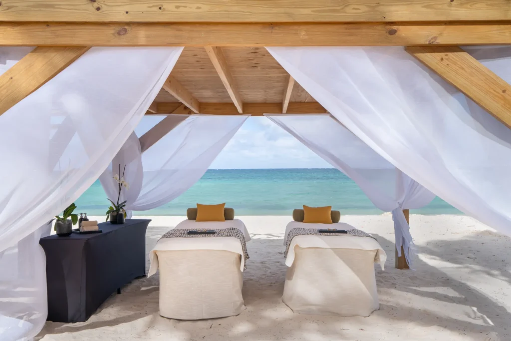 Beachfront spa cabana with massage beds overlooking the ocean at Dreams Flora Resort & Spa Punta Cana.