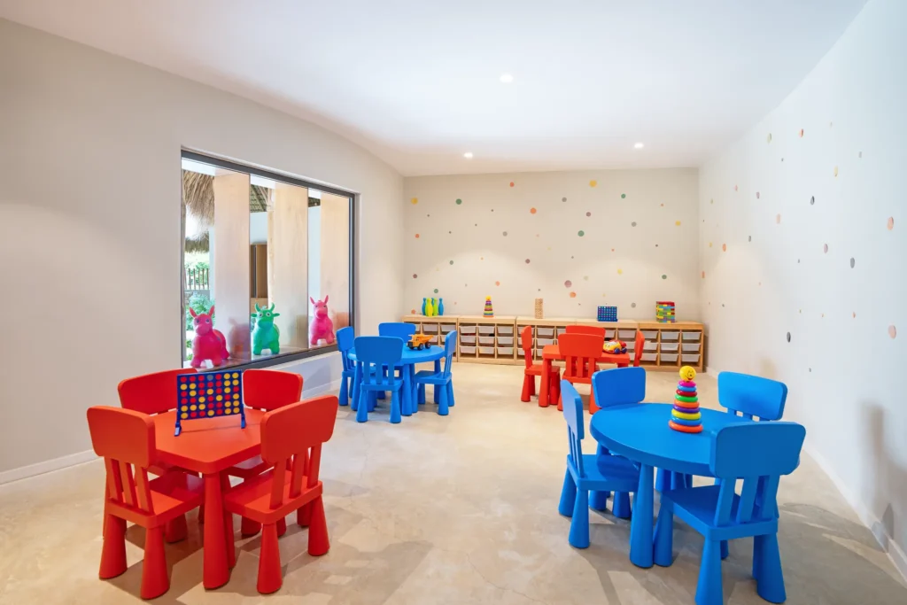 Kids club playroom with colorful tables and toys at Dreams Flora Resort & Spa Punta Cana.