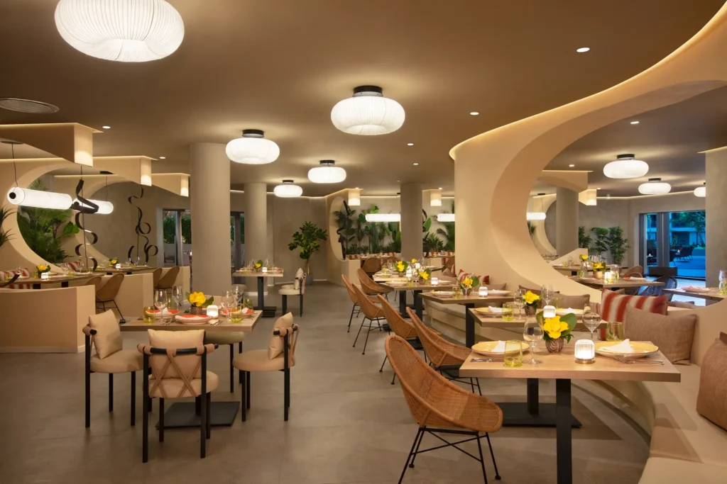 El Patio Mexican restaurant at Dreams Flora Resort & Spa featuring elegant dining space, warm lighting, modern décor, and intimate seating.