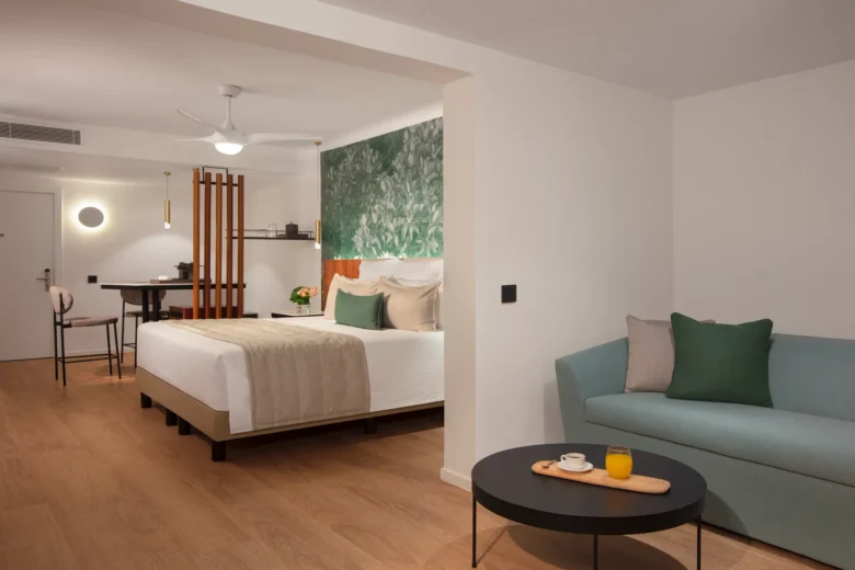 Junior Suite Pool View with king bed and seating area at Dreams Flora Resort & Spa Punta Cana.