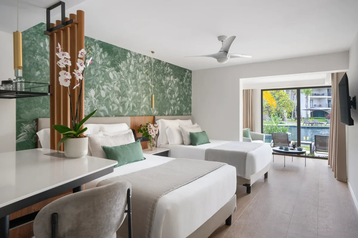 Junior Suite Swim Up with two double beds and pool access terrace at Dreams Flora Resort & Spa.
