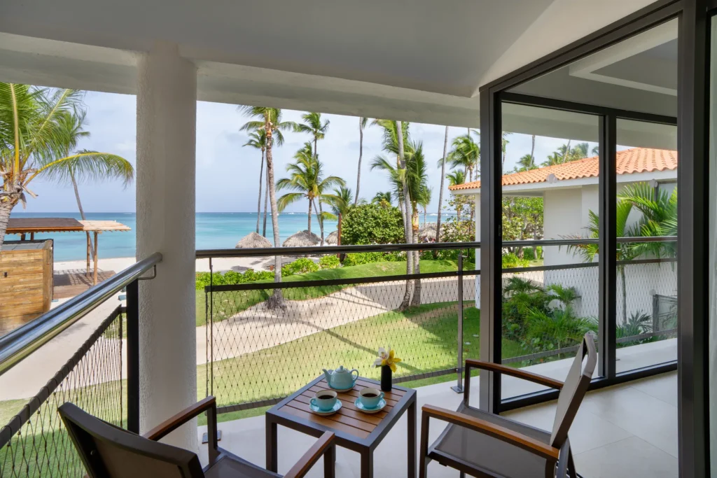 Preferred Club Junior Suite Ocean View balcony overlooking beach and palm trees at Dreams Flora Resort & Spa.