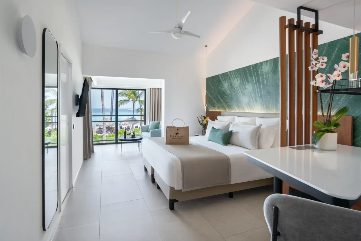 Preferred Club Junior Suite Ocean View king bedroom with seating area and ocean view at Dreams Flora Resort & Spa.