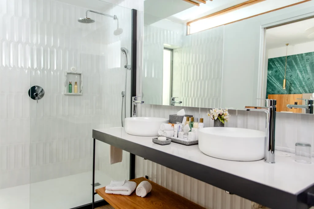 Preferred Club Junior Suite Partial Ocean View bathroom with dual sinks and walk-in shower at Dreams Flora Resort & Spa.