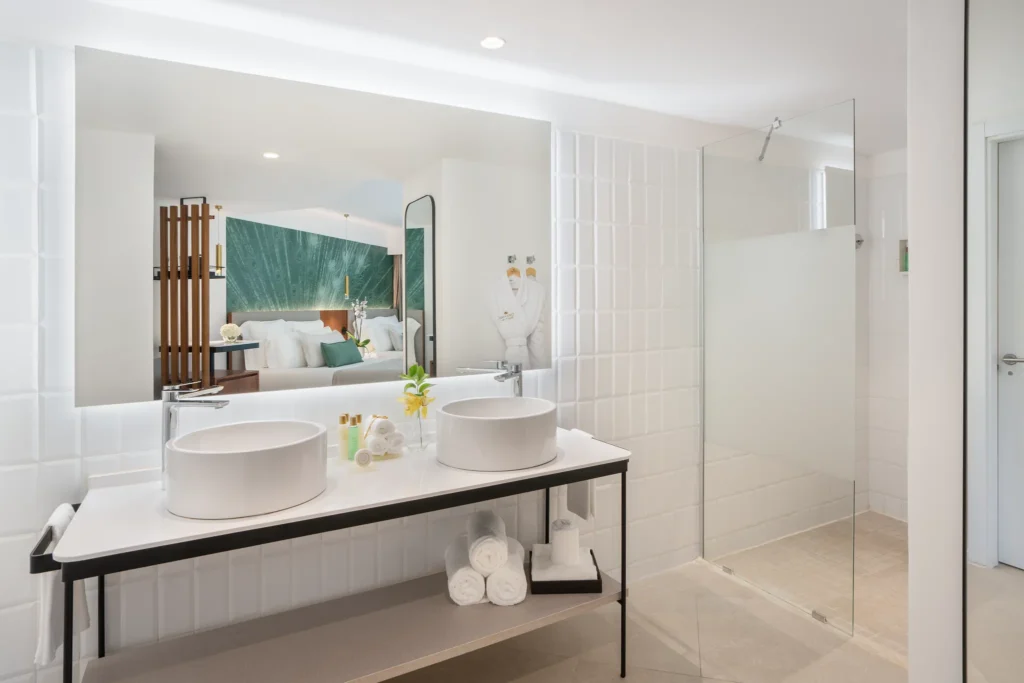 Preferred Club Junior Suite Swim Up bathroom with double vanity and walk-in shower at Dreams Flora Resort & Spa.