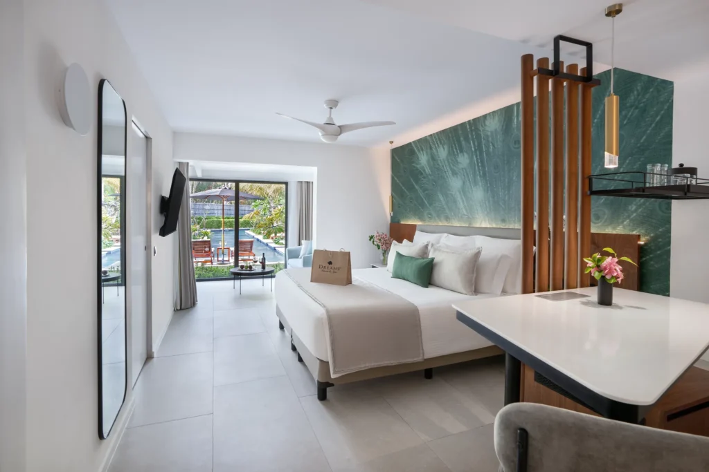 Preferred Club Junior Suite Swim Up king bedroom with modern décor at Dreams Flora Resort & Spa.
