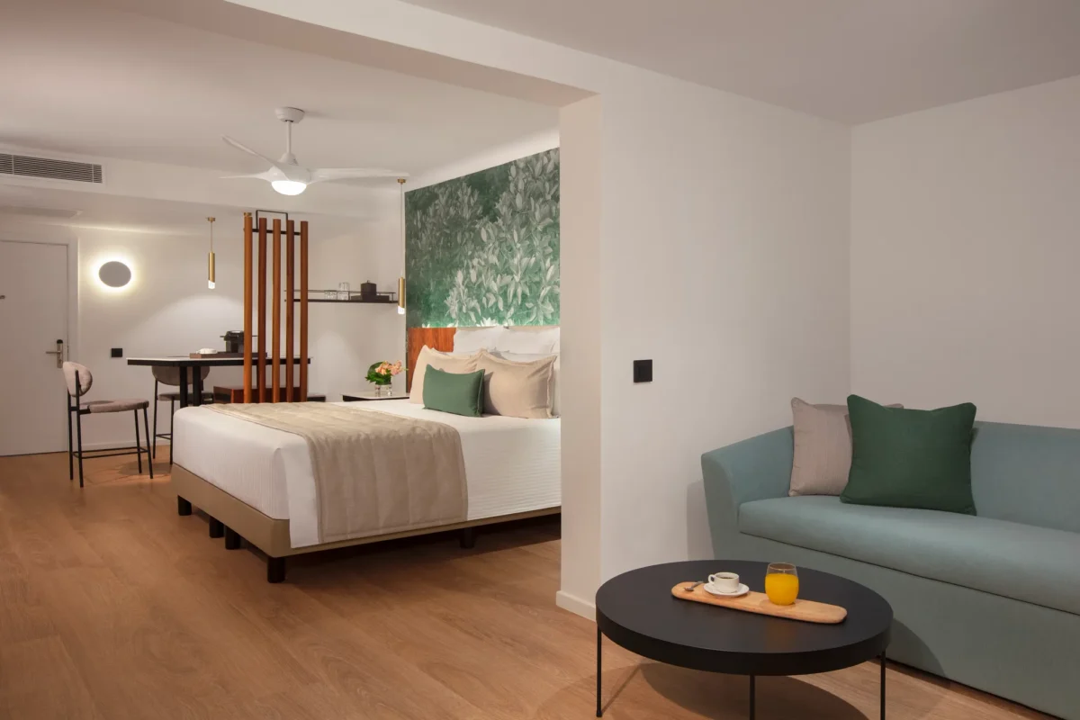 Preferred Club Junior Suite Tropical View with king bed and seating area at Dreams Flora Resort & Spa.