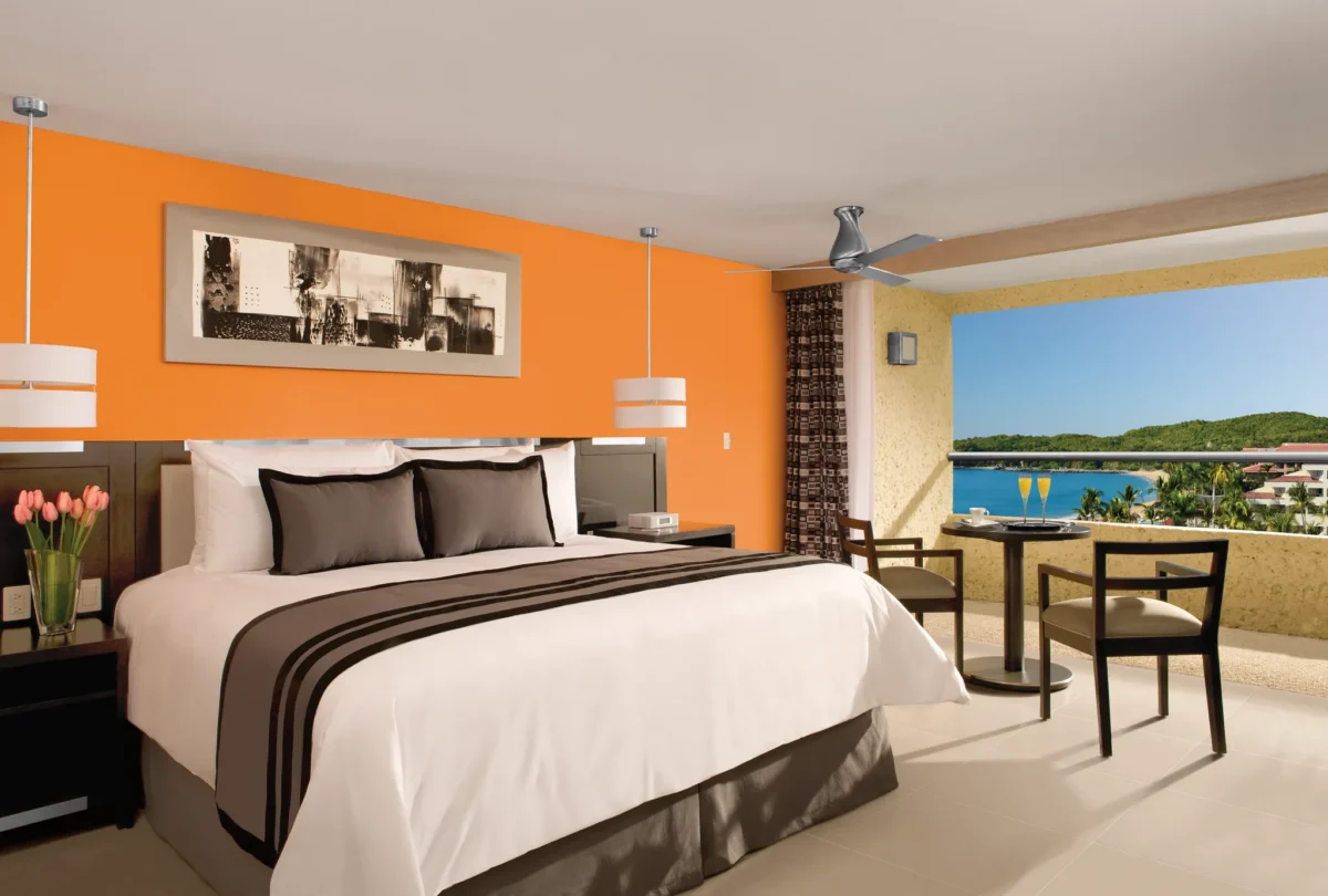 Deluxe Partial Ocean View room with king bed and private balcony at Dreams Huatulco Resort & Spa.