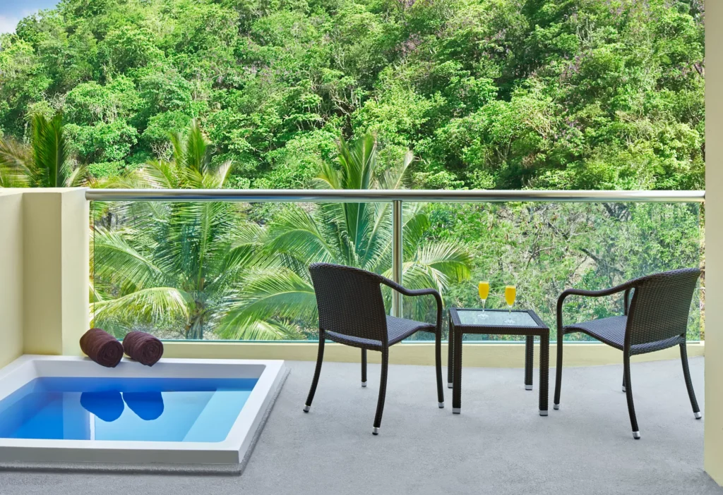 Private terrace with hot tub and tropical view at Deluxe Tropical View with Hot Tub room at Dreams Huatulco Resort & Spa.