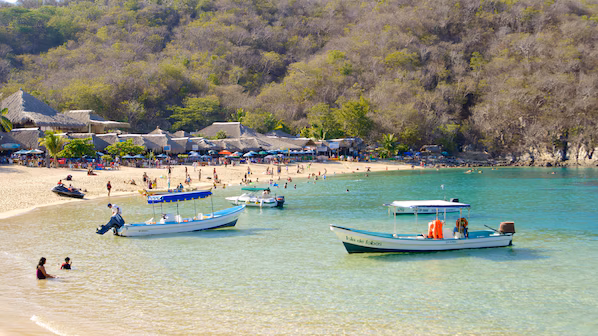 La Entrega Beach near Dreams Huatulco Resort & Spa with calm turquoise waters, sandy shoreline, and popular snorkeling area