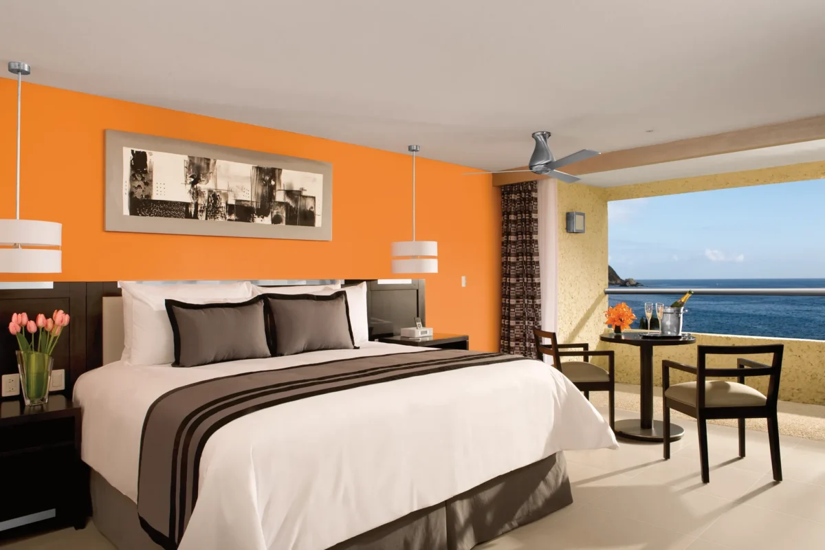 Preferred Club Deluxe Ocean Front room with king bed and private balcony at Dreams Huatulco Resort & Spa overlooking the ocean.