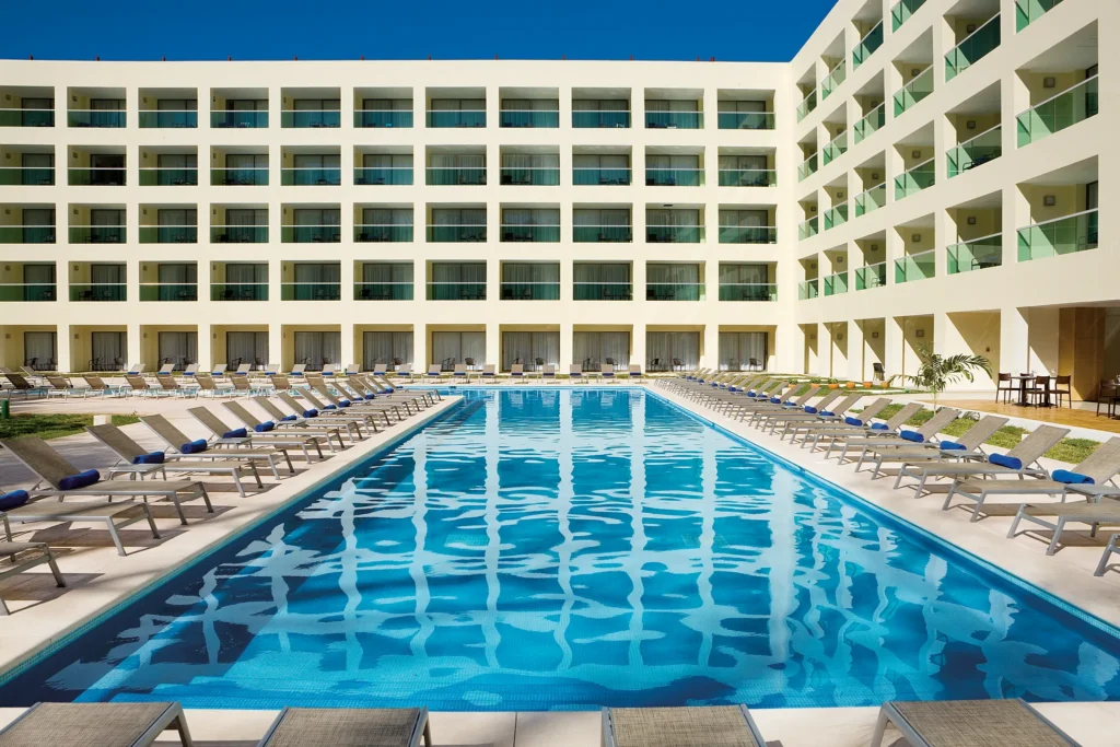 Preferred Club pool area at Dreams Huatulco Resort & Spa with lounge chairs and ocean views.