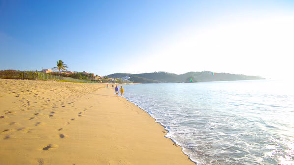 Zaachila Beach near Dreams Huatulco Resort & Spa with golden sand, gentle waves, and Pacific Ocean views