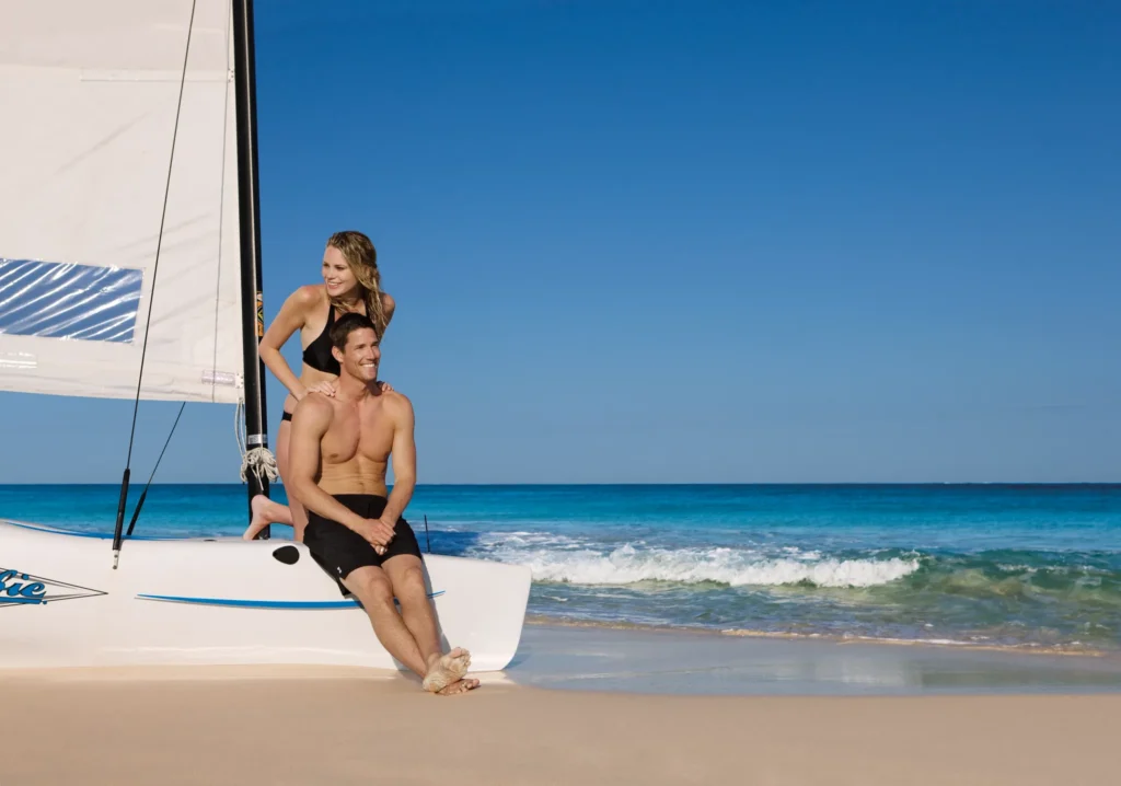 Couple relaxing on a catamaran along the beach at Dreams Jade Resort & Spa.