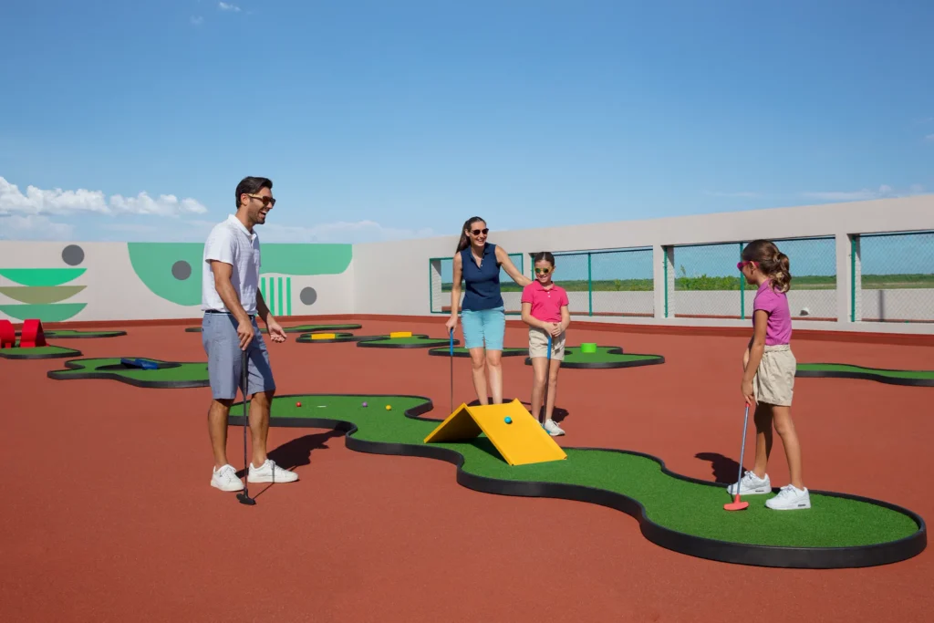 Family playing mini golf at Dreams Jade Resort & Spa in Puerto Morelos.