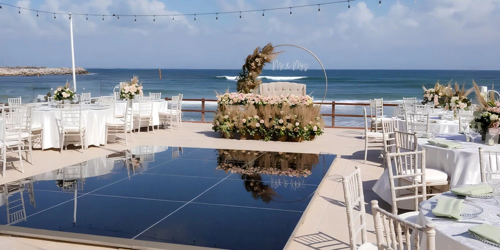 La Terraza oceanfront terrace wedding reception setup at Dreams Jade Riviera Cancun