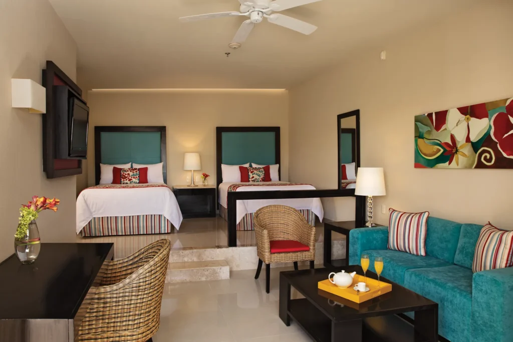 Family Suite Tropical View with two double beds and connecting layout at Dreams Jade Resort & Spa.