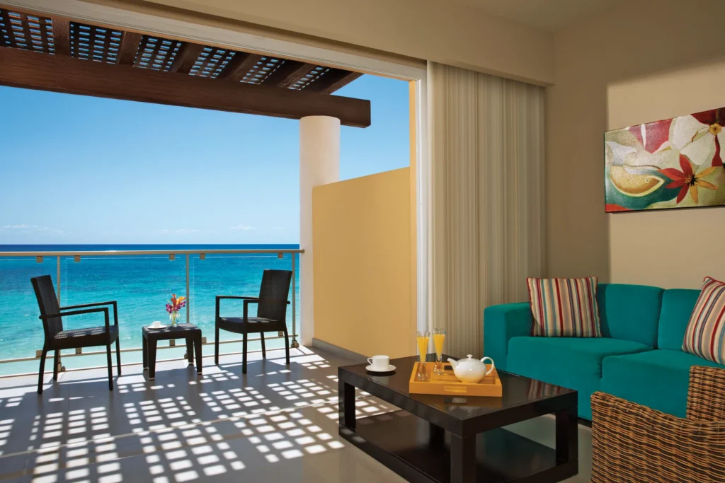Preferred Club Suite Ocean Front private balcony with seating and hot tub overlooking the Caribbean at Dreams Jade Resort & Spa.