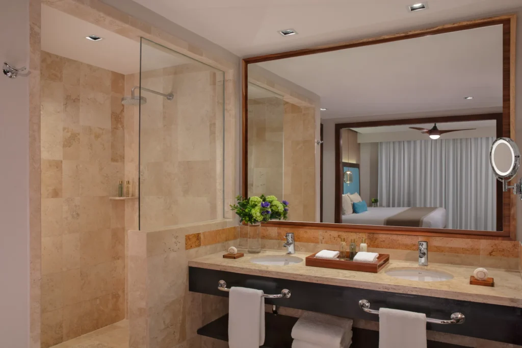 Preferred Club Suite Ocean Front bathroom with rain shower and double vanity at Dreams Jade Resort & Spa.