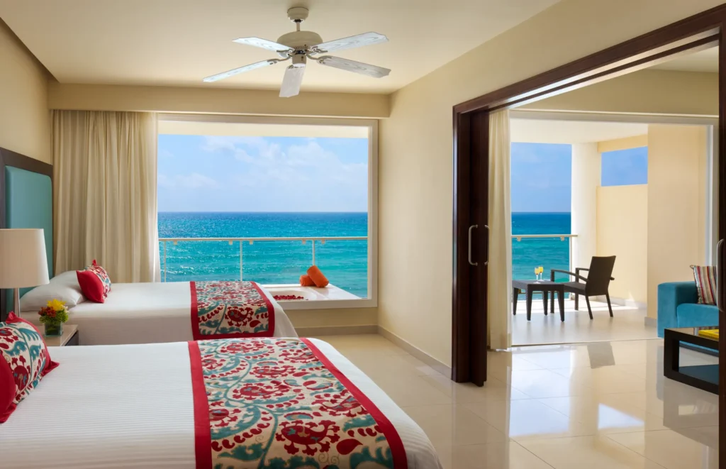 Preferred Club Suite Ocean Front with two double beds and private oceanfront balcony at Dreams Jade Resort & Spa.