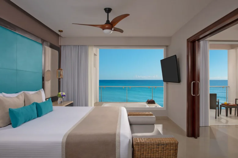 Preferred Club Suite Ocean Front king bedroom with hot tub and balcony overlooking the Caribbean at Dreams Jade Resort & Spa.