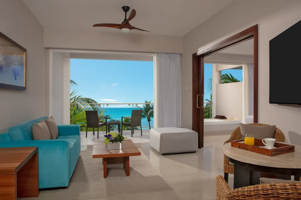 Preferred Club Suite Ocean View living area with sofa and balcony access at Dreams Jade Resort & Spa.