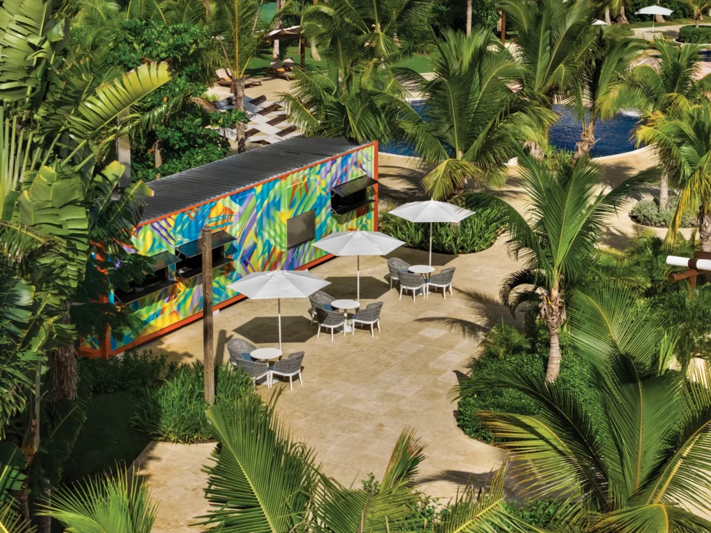 Catch the Wave bar at Dreams La Romana Resort & Spa featuring tropical cocktails, beachside seating, and a vibrant oceanfront atmosphere.