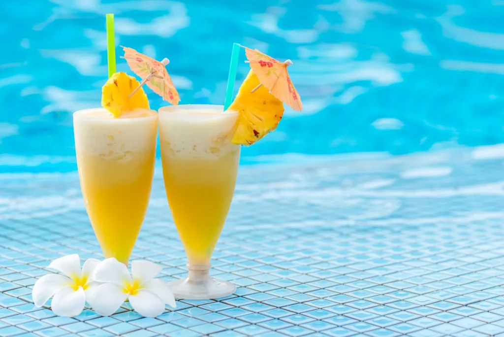 Las Palmas Swim-Up Bar at Dreams La Romana Resort & Spa featuring tropical cocktails, in-pool seating, and a relaxing resort pool atmosphere.