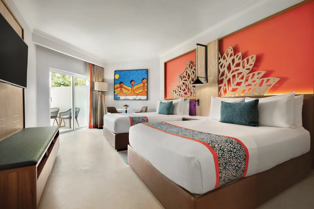 Preferred Club Swim-Out Garden View room with two queen beds and direct pool access at Dreams La Romana Resort & Spa.
