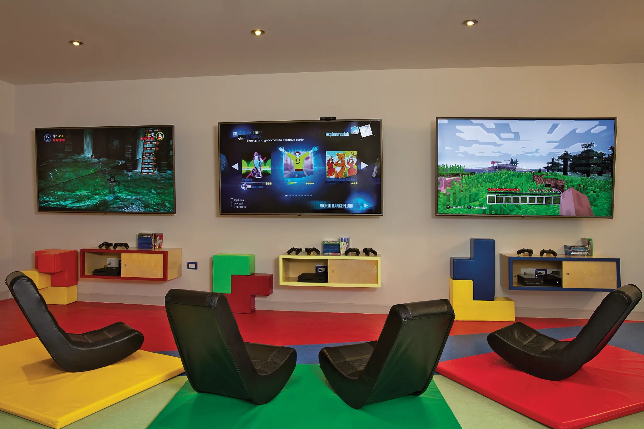 Kids gaming lounge with video game consoles and screens at Dreams Los Cabos Suites Golf Resort & Spa Explorer’s Club.