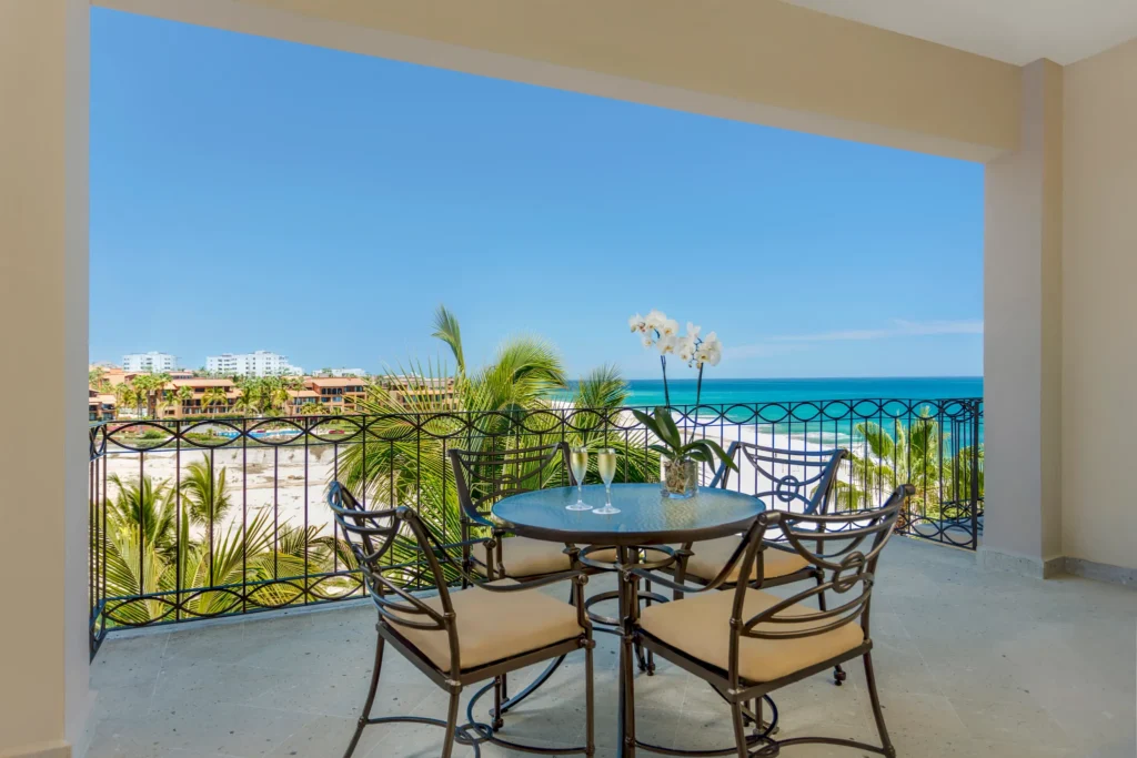 Family Junior Suite Ocean View private balcony with dining table overlooking the Sea of Cortez at Dreams Los Cabos Suites Golf Resort & Spa.