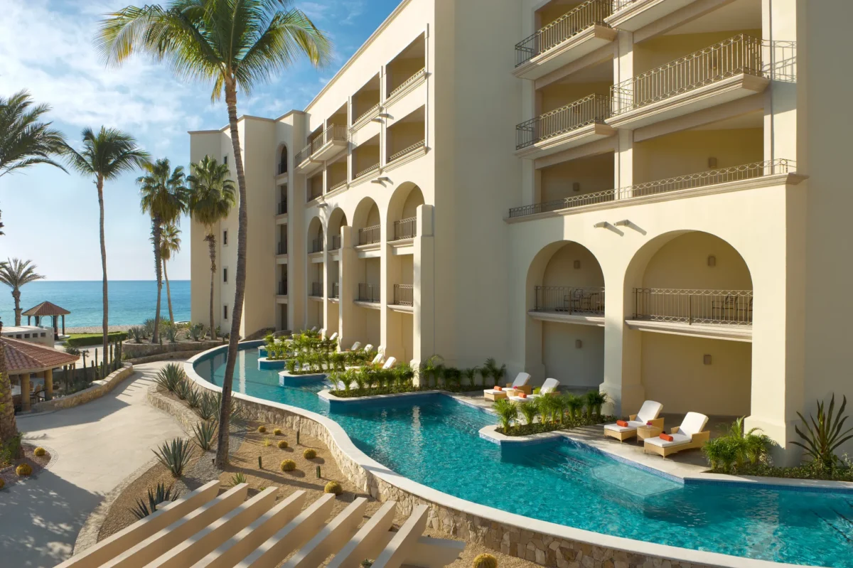 One Bedroom Suite Pool View Swim Out terrace and lazy river-style pool at Dreams Los Cabos Suites Golf Resort & Spa.