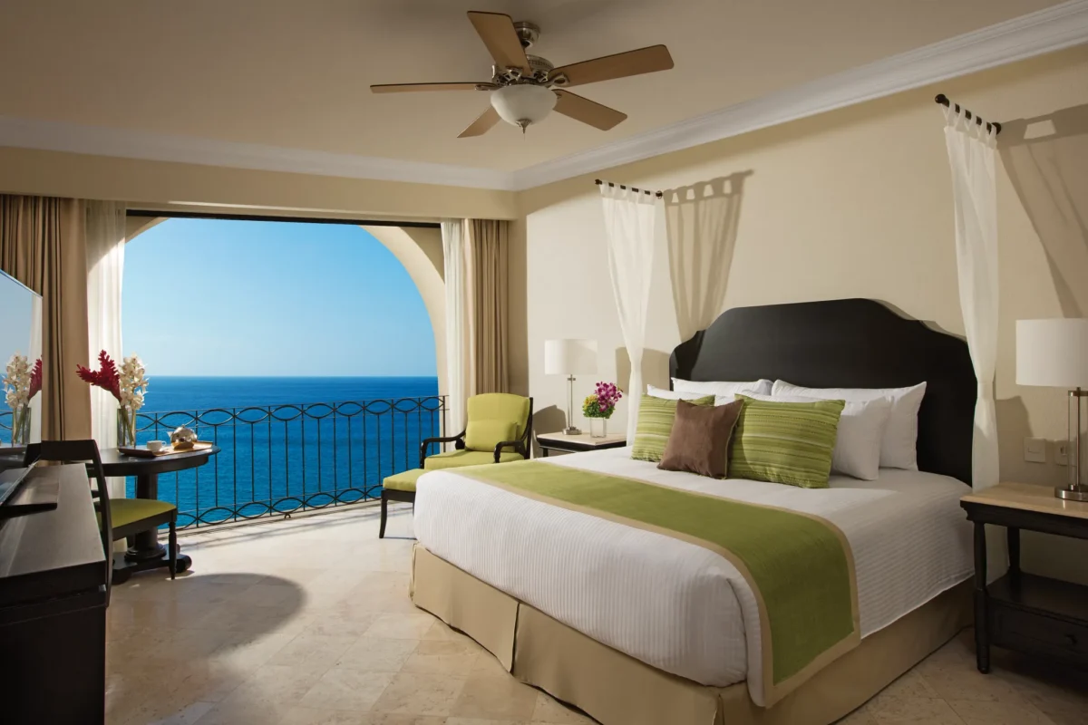 Oceanfront king bedroom with balcony view of the Sea of Cortez in the Preferred Club Family Master Two Bedroom Suite at Dreams Los Cabos.