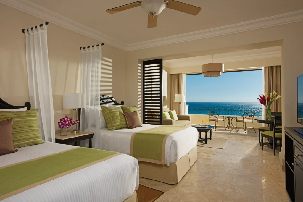 Preferred Club Junior Suite Ocean Front with two double beds and private balcony overlooking the Sea of Cortez at Dreams Los Cabos Suites Golf Resort & Spa.